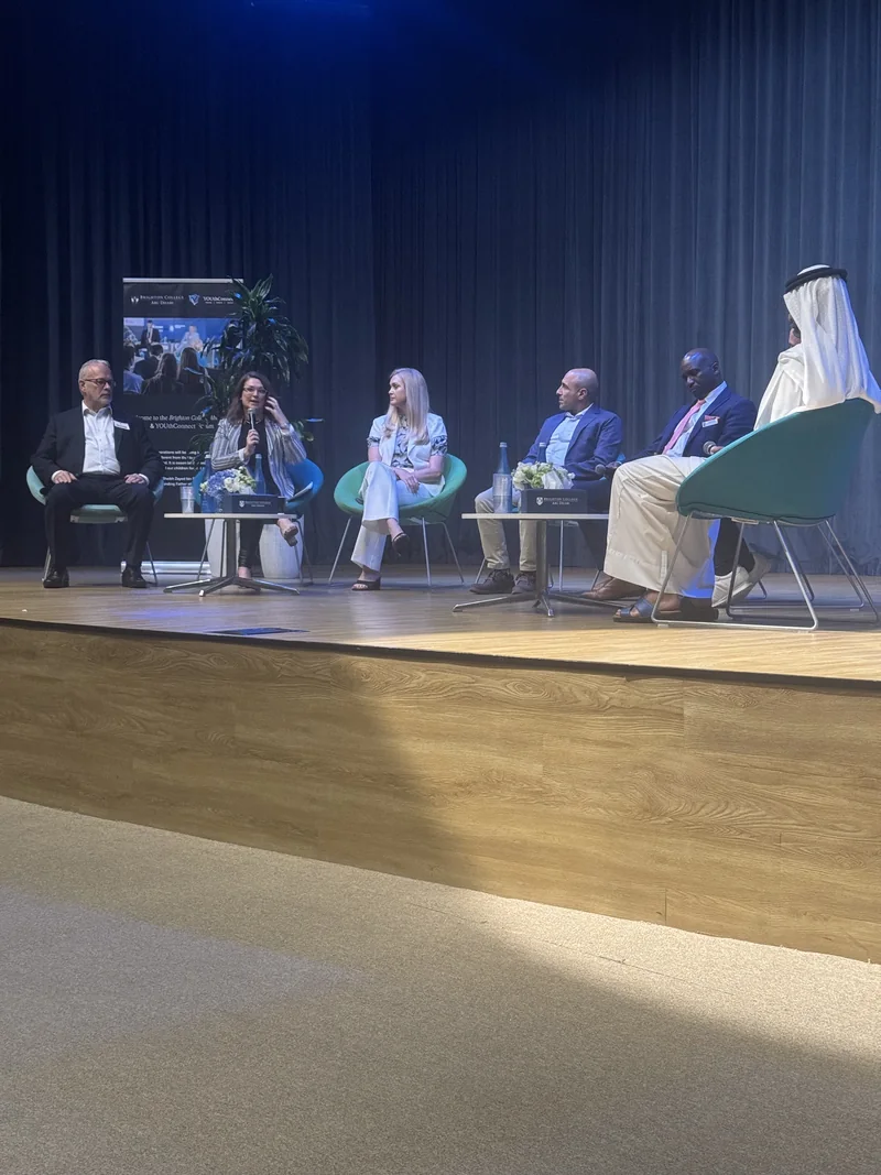Industry and community leaders sharing perspectives on stage