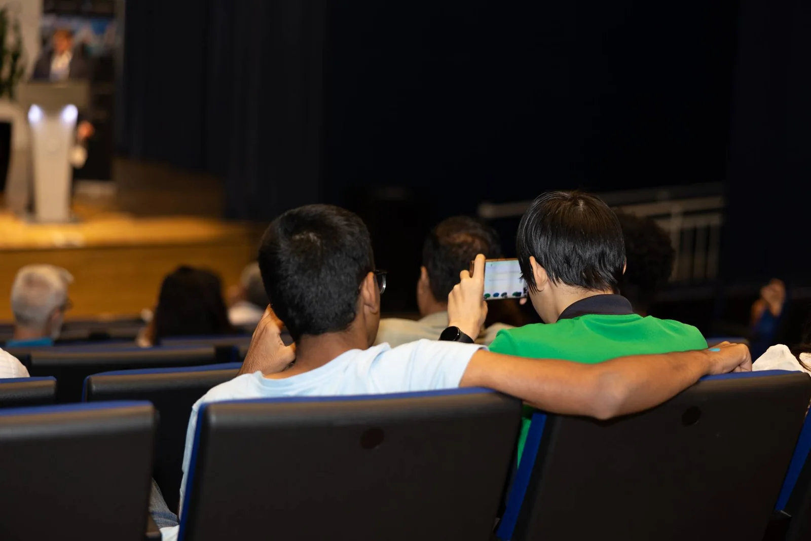 Young participants engaging with a presentation at the previous forum.