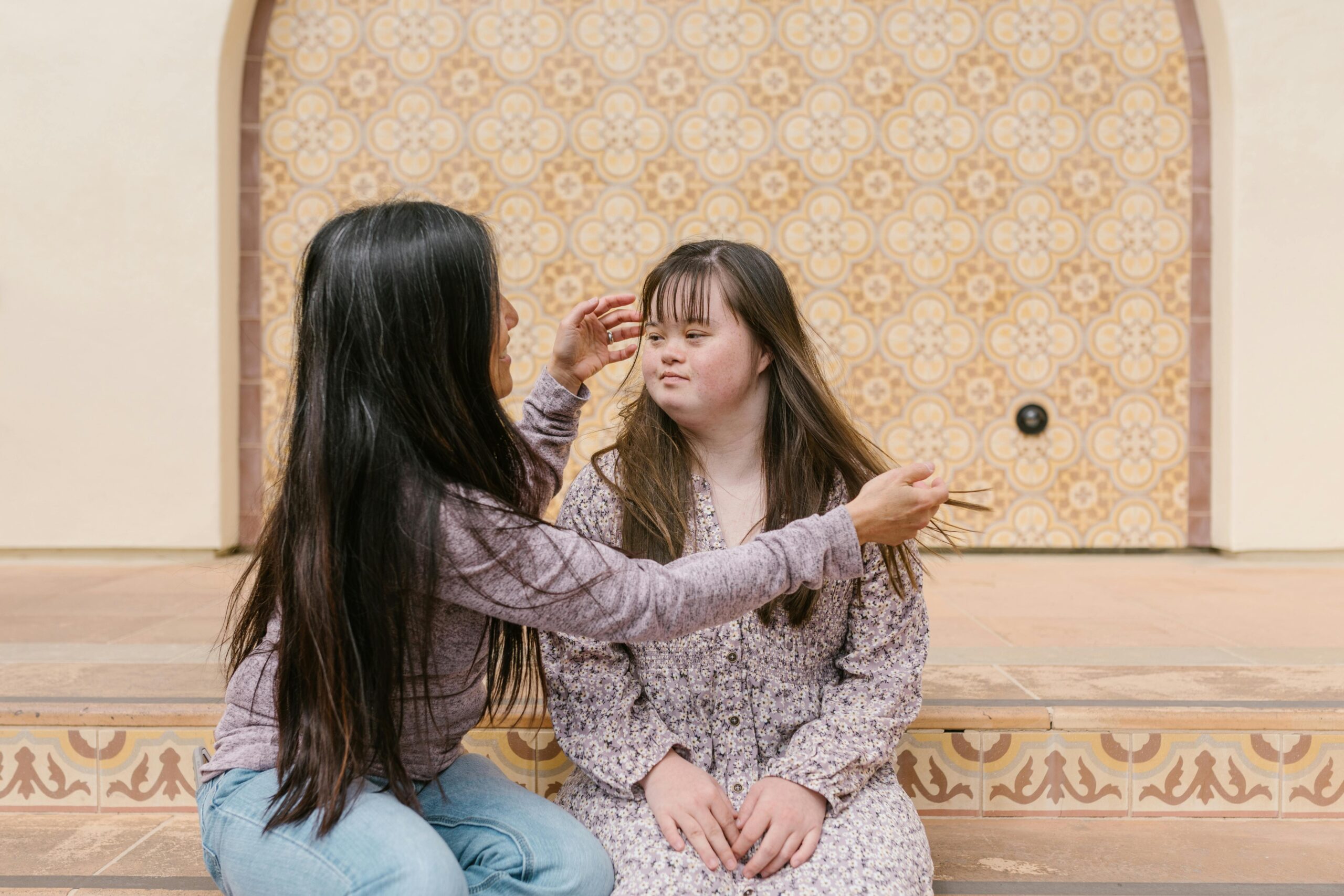 A young woman with Down syndrome receiving personal support