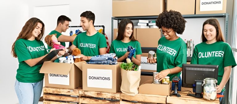 Young volunteers sorting donated items at a community service project.