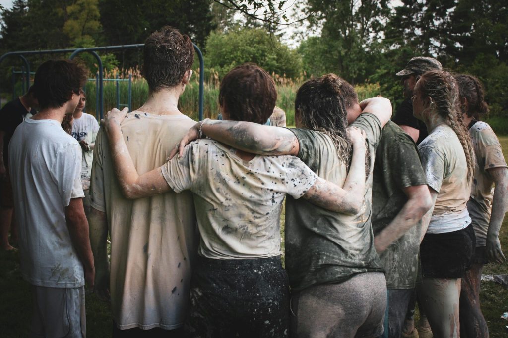 A group of young people standing together after an outdoor activity.