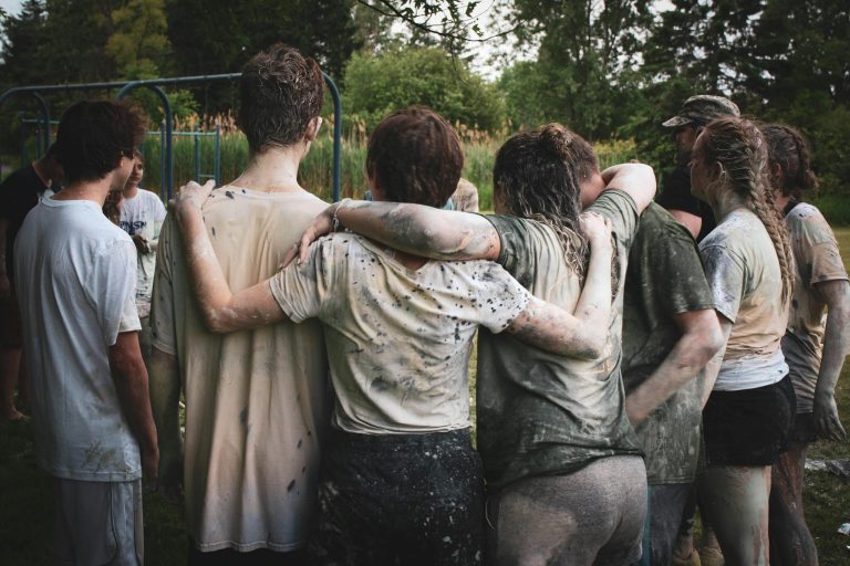 A group of young people standing together after an outdoor activity.
