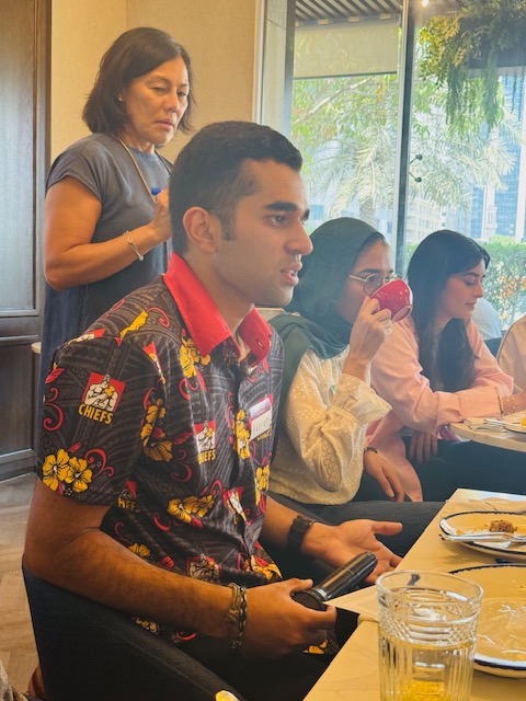 A participant contributes during a discussion at the workshop table.