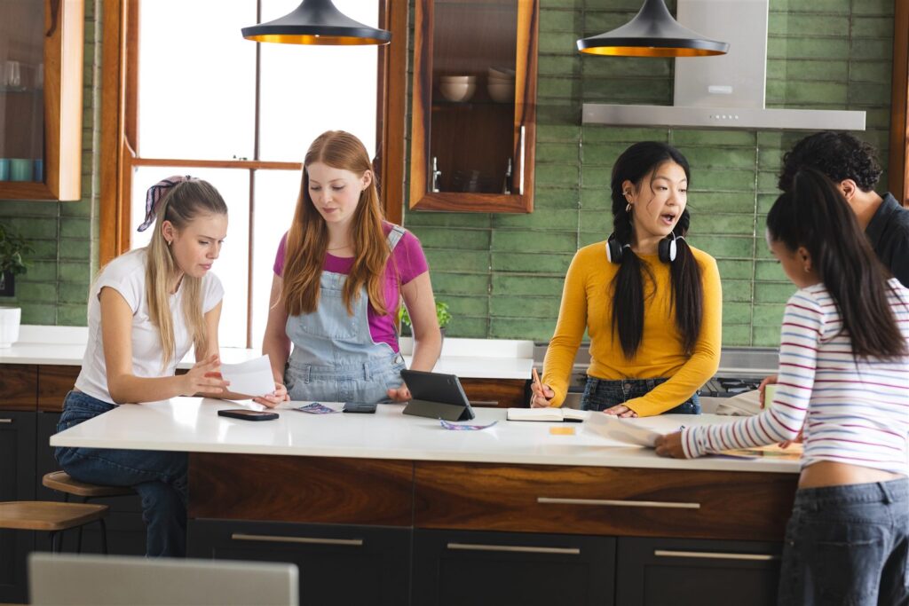 Young women collaborating around a table during a workshop.